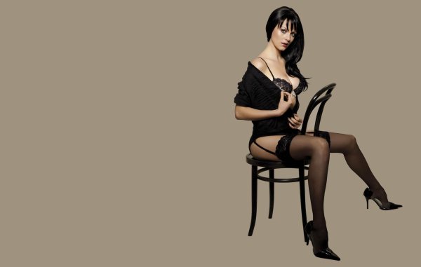 Yana Gupta в чулках на стуле показывает красоту